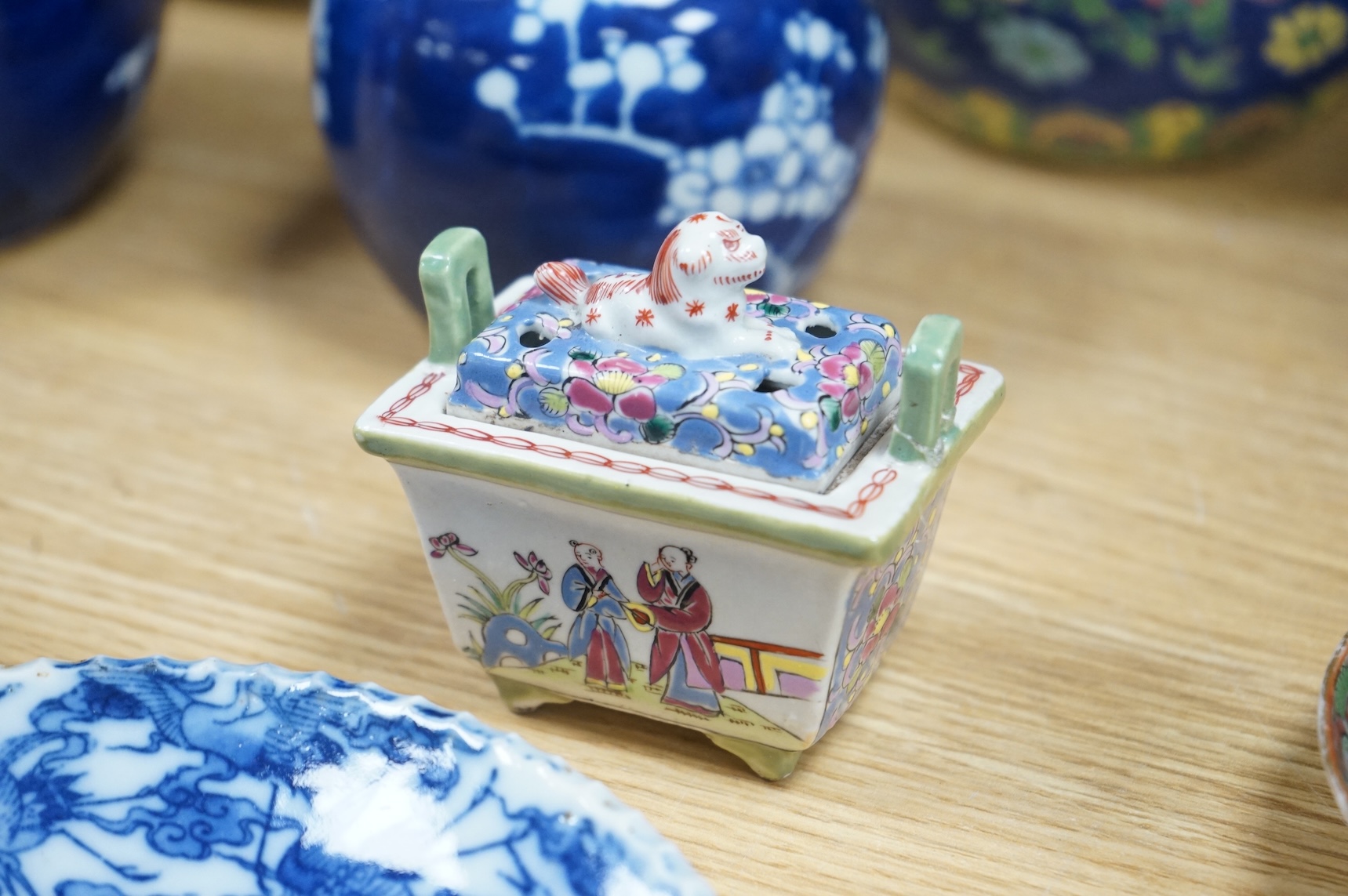 Fourteen pieces of Chinese porcelain and pottery, 19th/20th century to include a pair of blue and white ginger jars, famille rose cup and saucer and a cloisonné pot and cover in the form of an apple, largest 27cm high